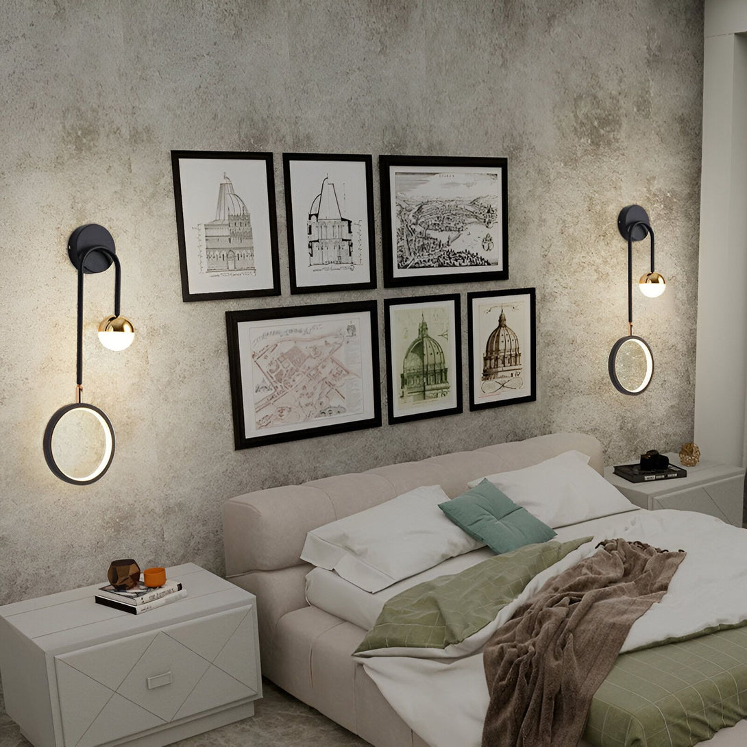 Une image d'une applique murale de salon. L'applique est noire avec un abat-jour rond en métal doré. Elle est fixée au mur au-dessus d'un lit. Il y a des cadres avec des dessins architecturaux accrochés au mur derrière le lit. SI-404465915X,SI-9313062666,SI-8244315253,SI-2796814408,SI-4937030671,SI-7340808590,SI-742479745X,SI-8530495985,SI-6643510554,SI-3922651682,SI-5308641021,SI-222868936X,