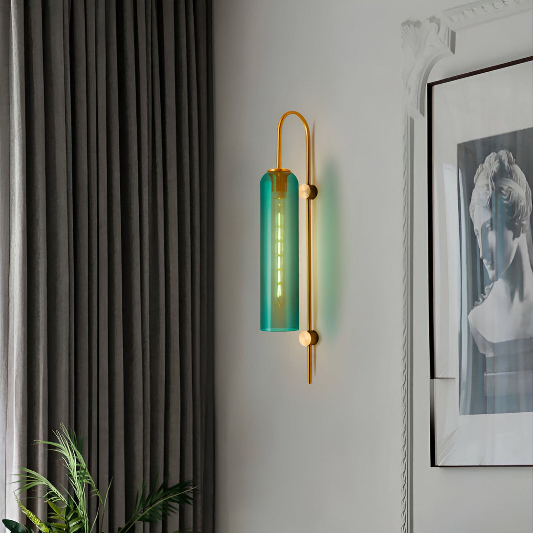 Une image d'une applique murale en verre vert et métal doré. L'applique est de forme cylindrique et émet une lumière douce et diffuse. Elle est fixée au mur par un support en métal doré. L'applique est idéale pour une utilisation dans un salon, une chambre ou un couloir. OL-7762214003,OL-1185492895,OL-0122222709,OL-6550702720,OL-2563449324,OL-1038284295,OL-6210676383,
