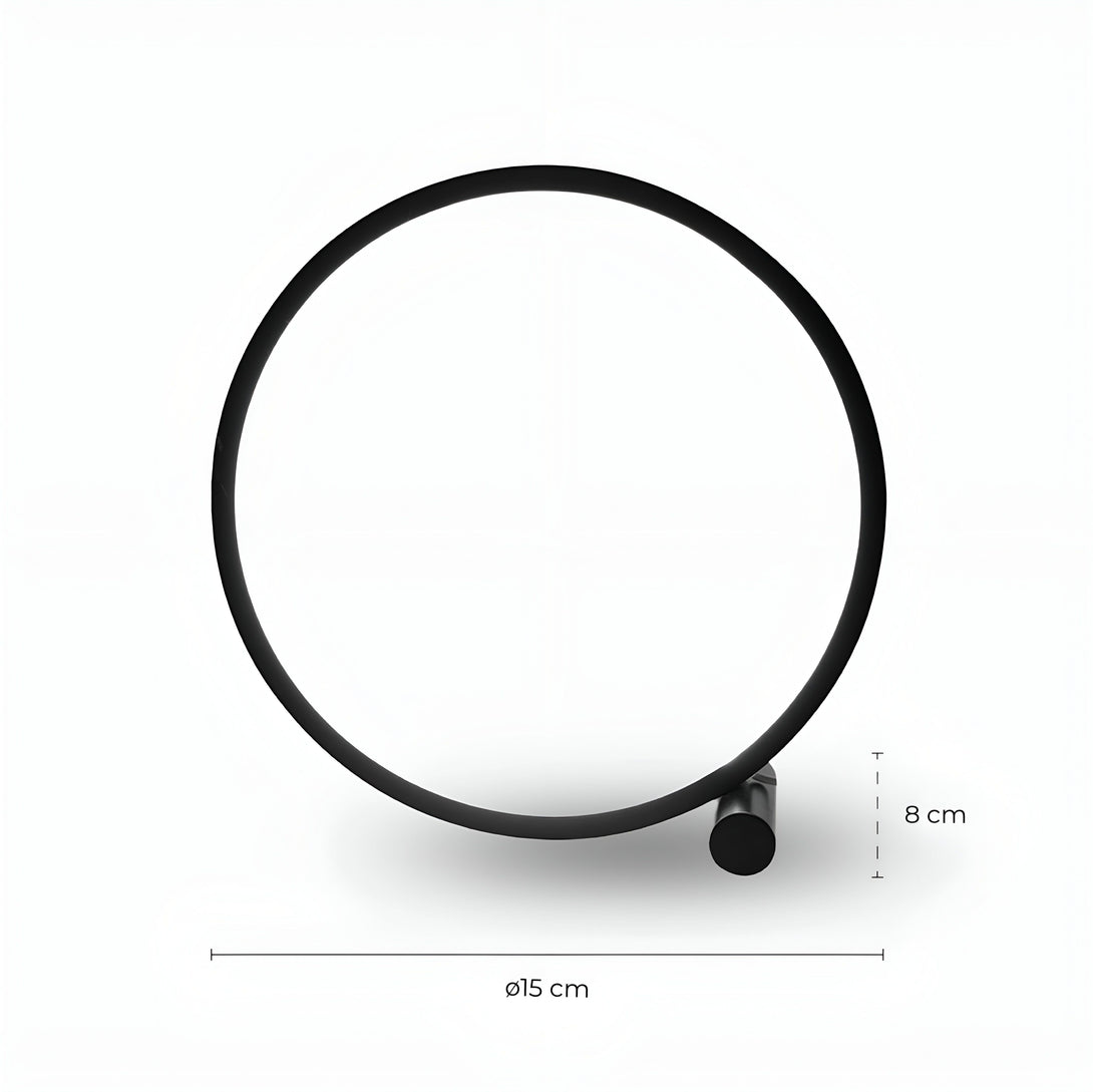Une image d'une lampe noire en forme de cercle. La lampe est posée sur une surface blanche. CE-4626626394,CE-0944412238,CE-2511648865,CE-0068266804,