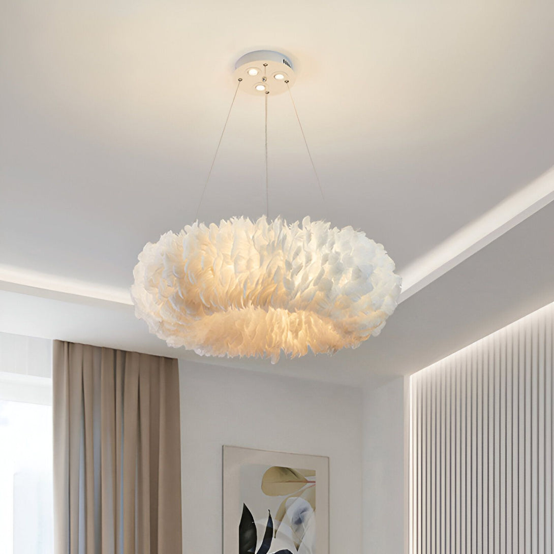 L'image représente un lustre rond en plumes blanches. Il est suspendu au plafond et diffuse une lumière douce et tamisée. Le lustre est idéal pour une chambre à coucher ou un salon.