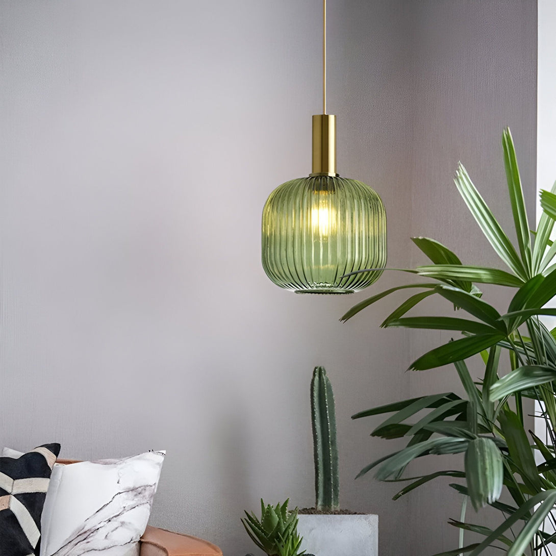 Une lampe en verre vert suspendue au plafond. À côté, se trouve un cactus et une plante verte. LI-8529220781,LI-4720739318,LI-9433830652,LI-6287765305,